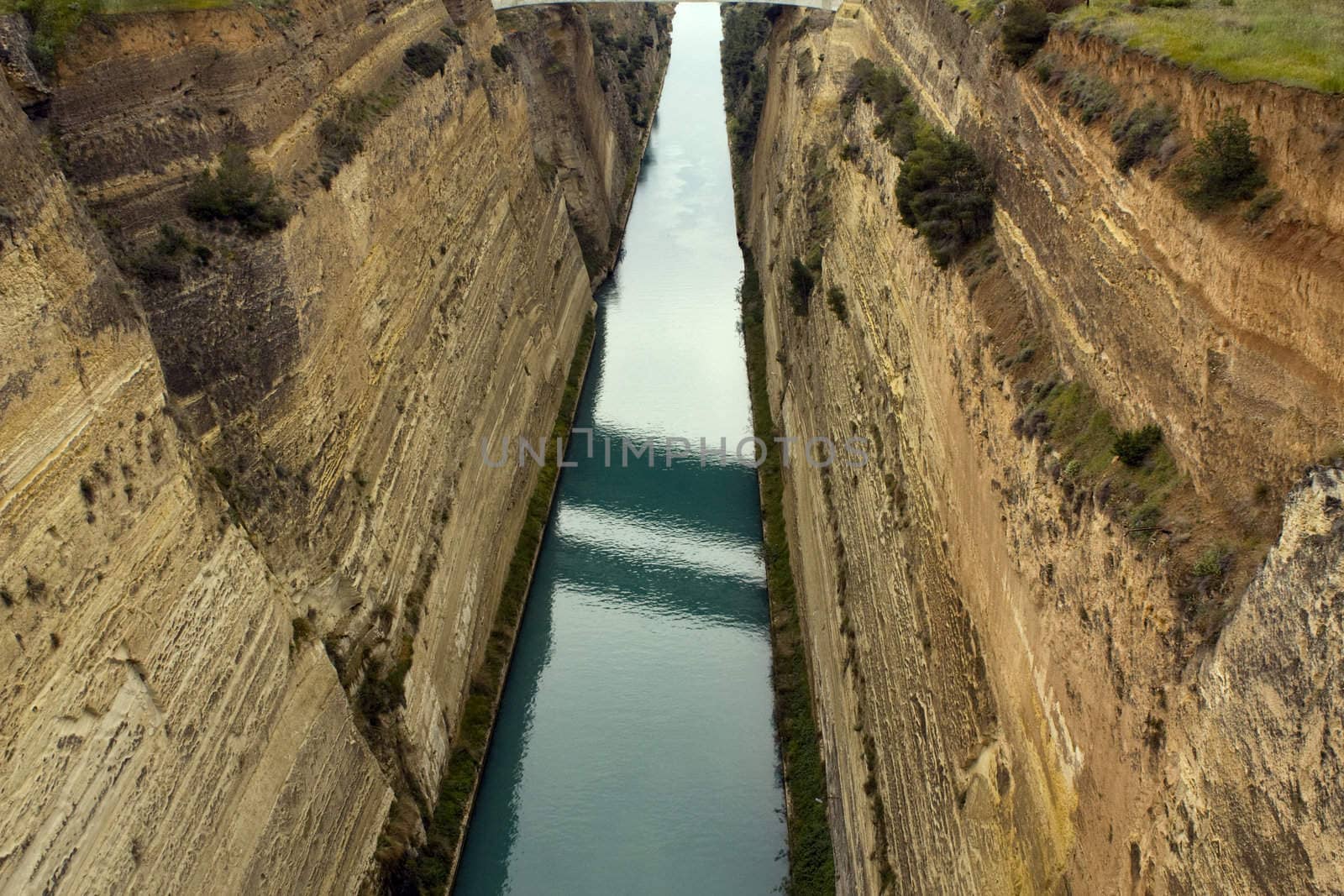 View of Corinth Canal in Greece, which cuts through the narrow Isthmus of Corinth and separates the Peloponnesian peninsula from the Greek mainland. The canal is 6.3 km in length and was built between 1881 and 1893.