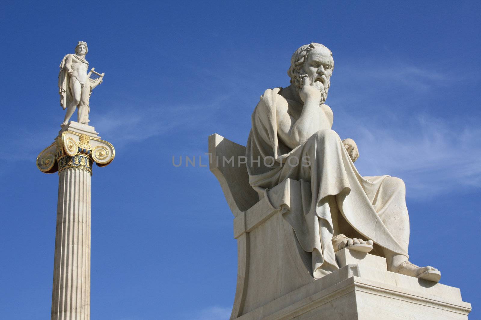 Neoclassical statues of Socrates (Greek ancient philosopher) and Apollo (god of  the sun, medicine and the arts) in front of the Academy of Athens, Greece.