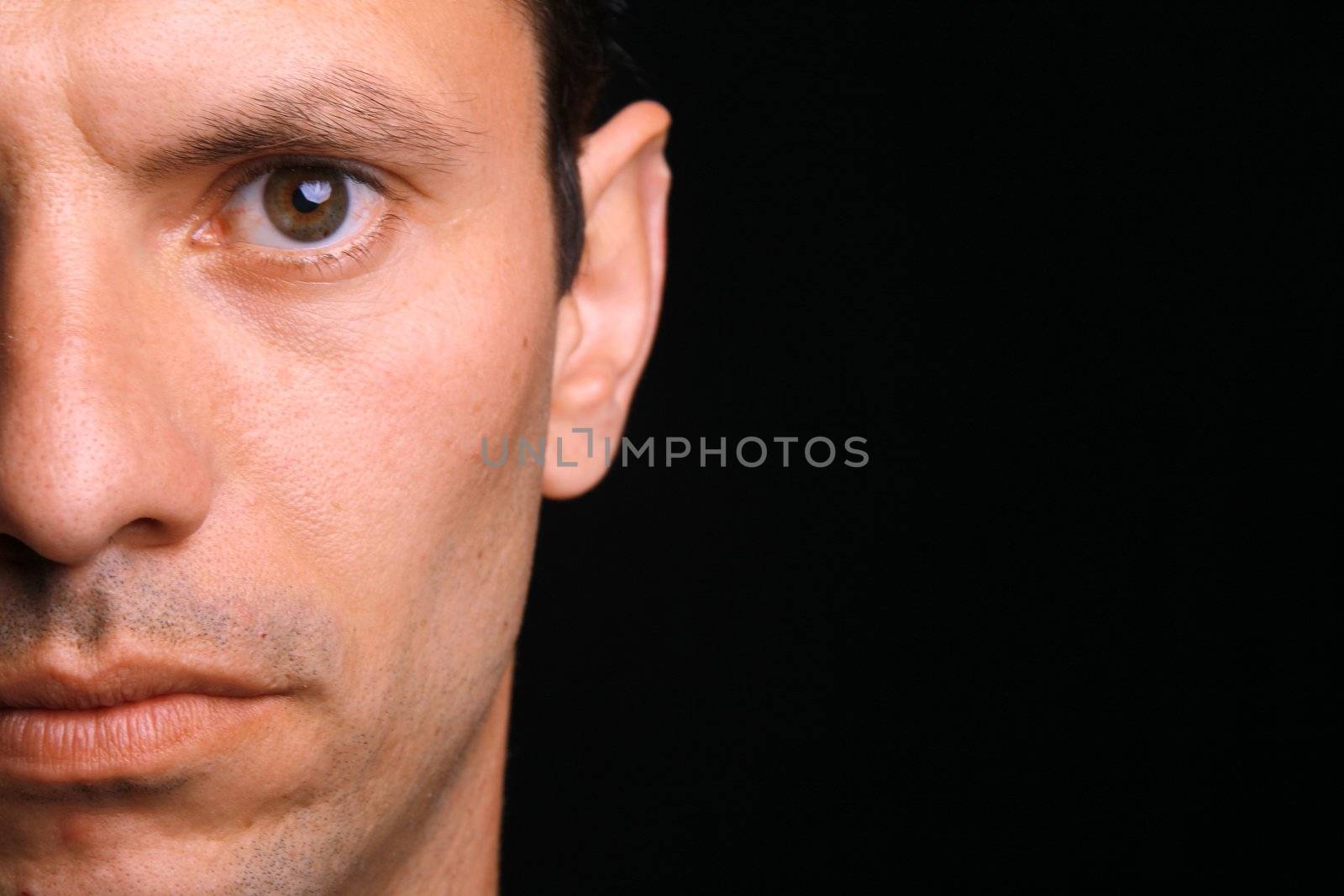 young man over black background