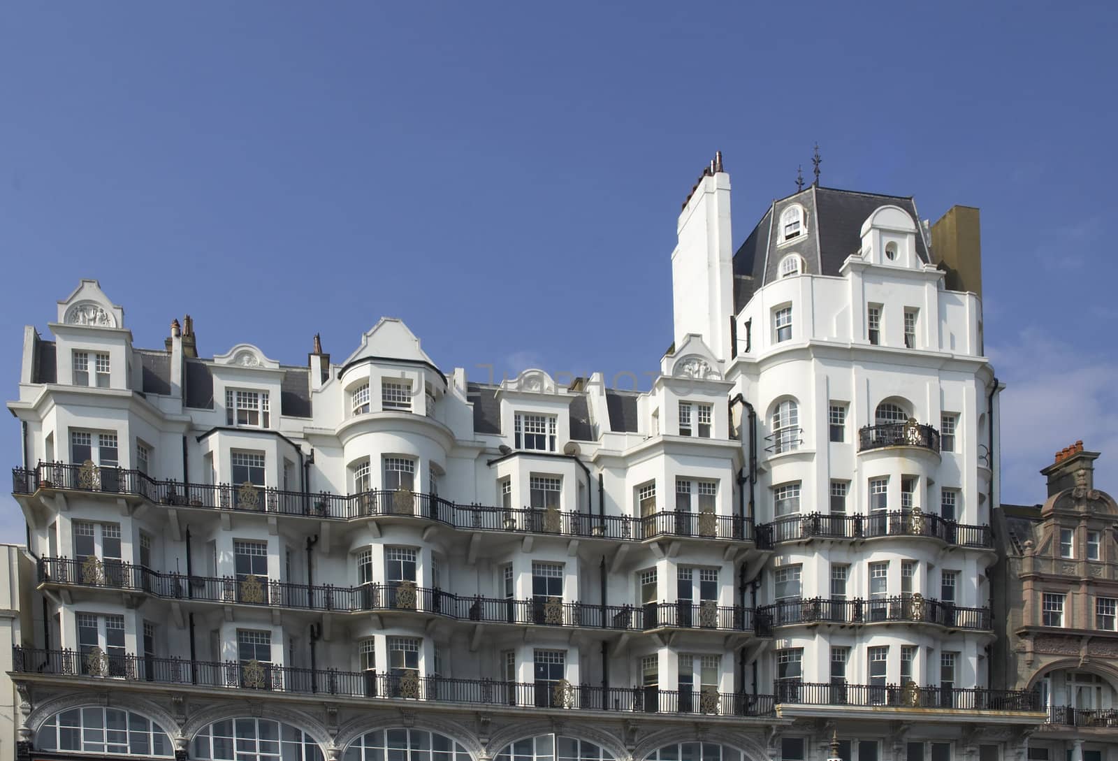 An old white victorian buildind with balconys