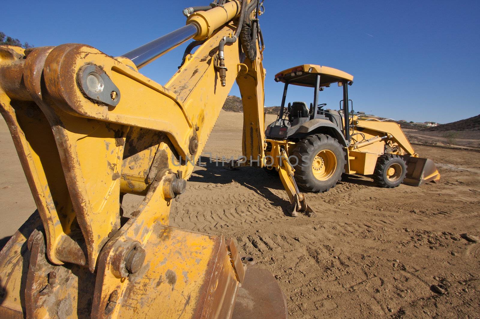 Tractor at a Cunstruction Site and dirt lot.