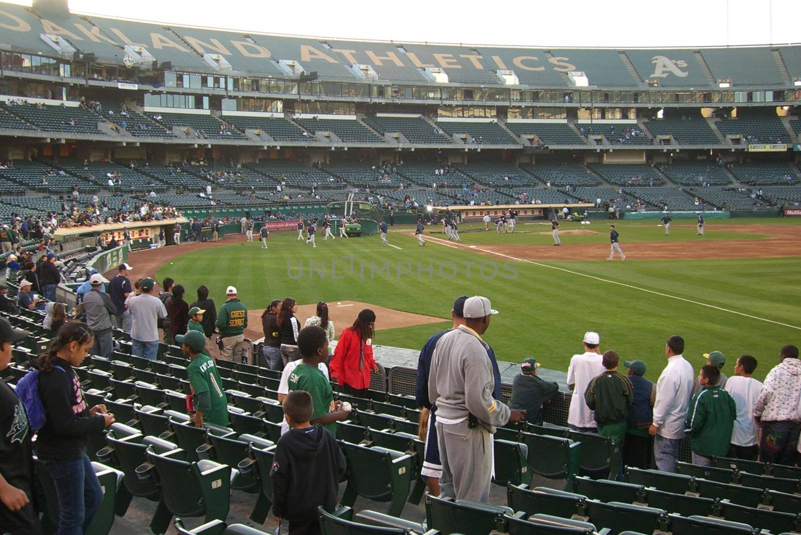Athletics fans gather to watch batting practice for a late season baseball game