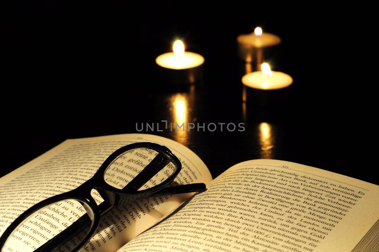 book candle and glasses with black copyspace