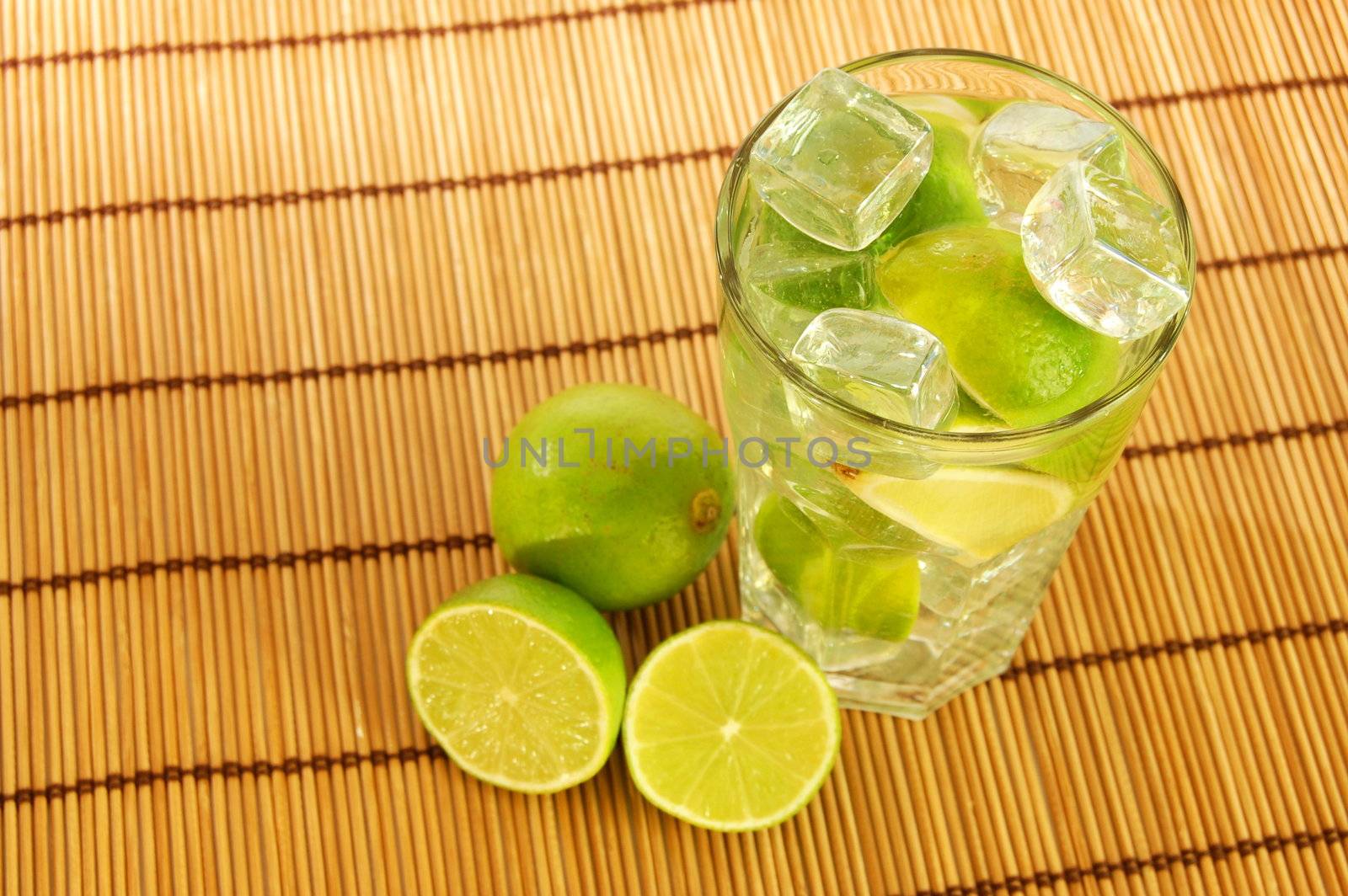 Caipirinha party cocktail with lemon and ice cubes