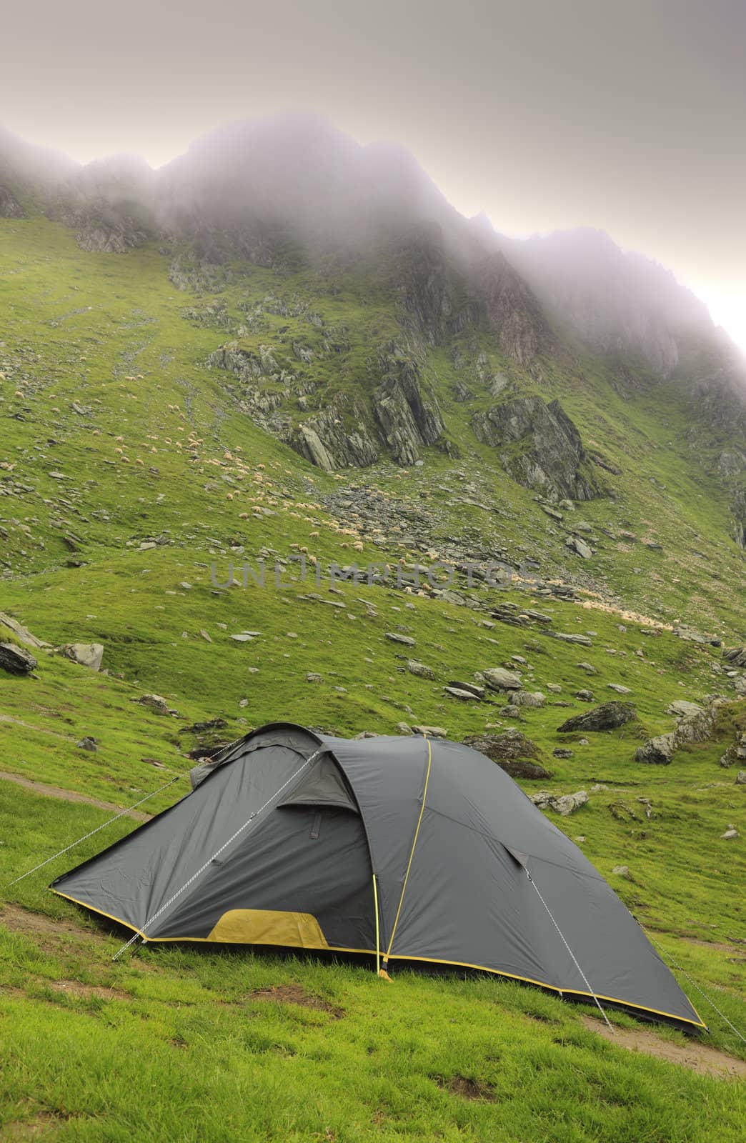 Tent in a mountaneos area during a cloudy moment.Location:Fagaras mountains,Romania.