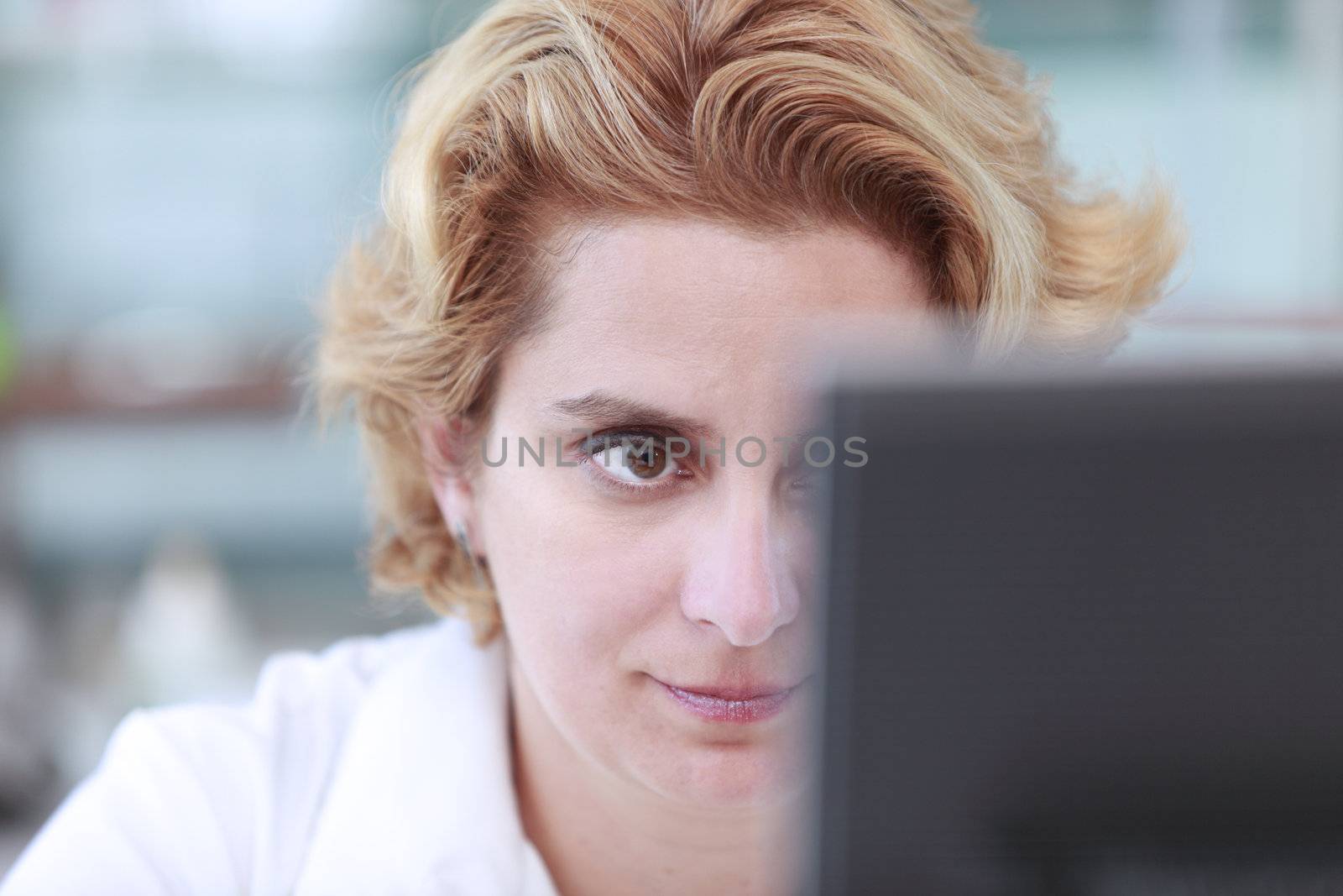 Close up of the eye of a female researcher in front of a computer monitor in a laboratory.