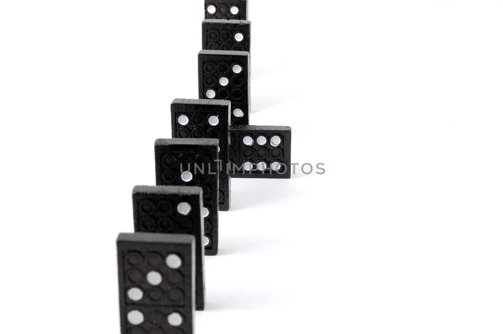 row of dominoes including a special domino stone isolated on white background