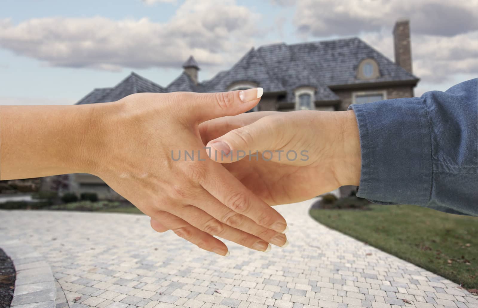 Man and woman shaking hands in front of a new house. by Feverpitched