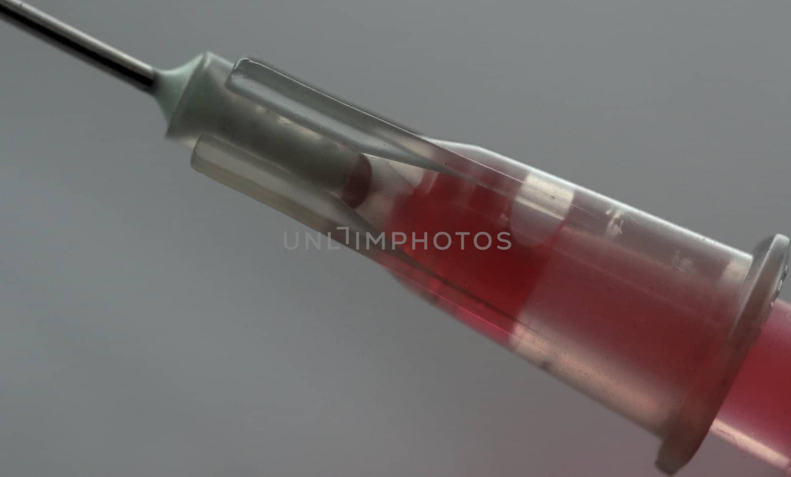 macro of syringe needle with red liquid