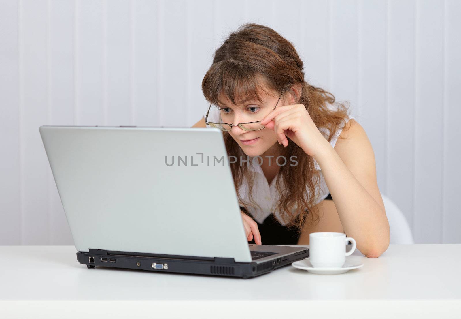 Young girl with glasses working in the Internet