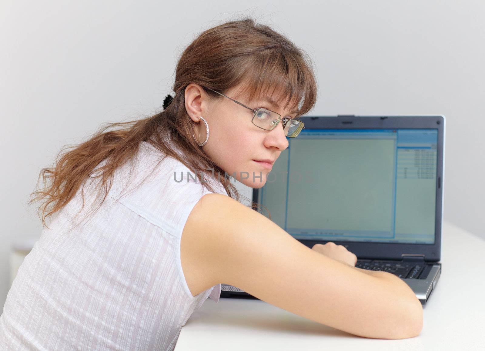 Young woman with glasses working in the Internet