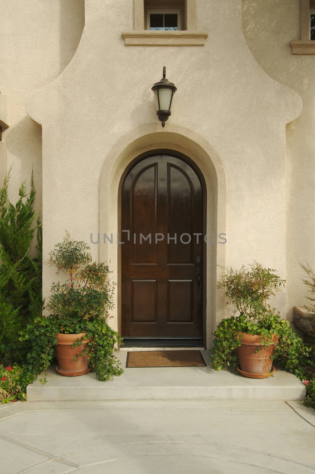 A newly constructed, modern american home doorway and patio.