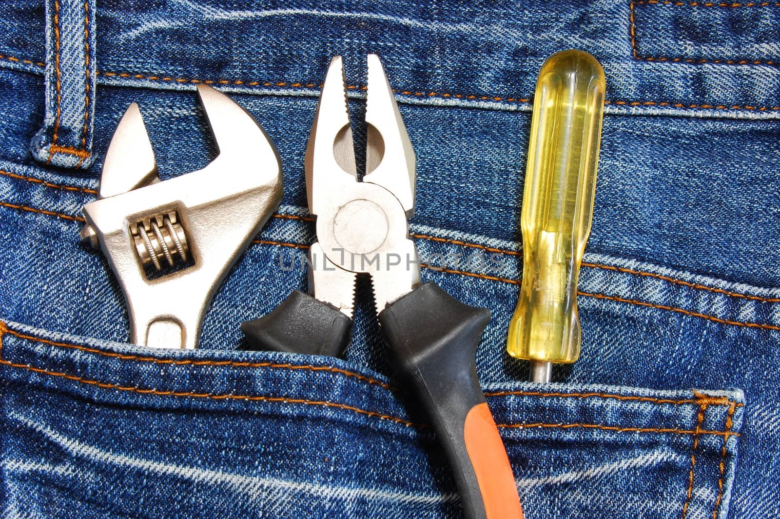 tools like caliper screwdriver and spanner in jeans pocket