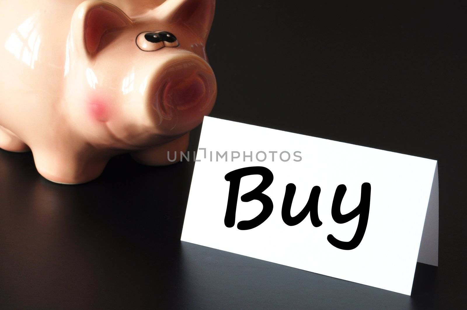 buy on stock market concept with piggy bank on black