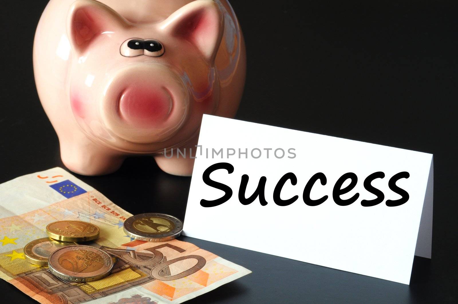 financial success concept with piggy bank on black background