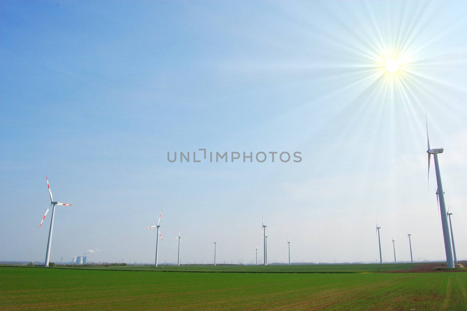 wind turbine under blue sky for alternative energy