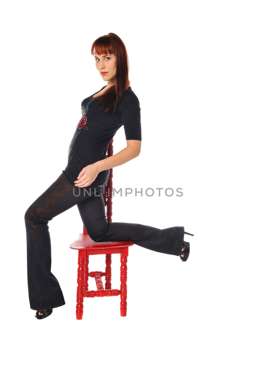 Attractive young woman in a tall back chair on a white background