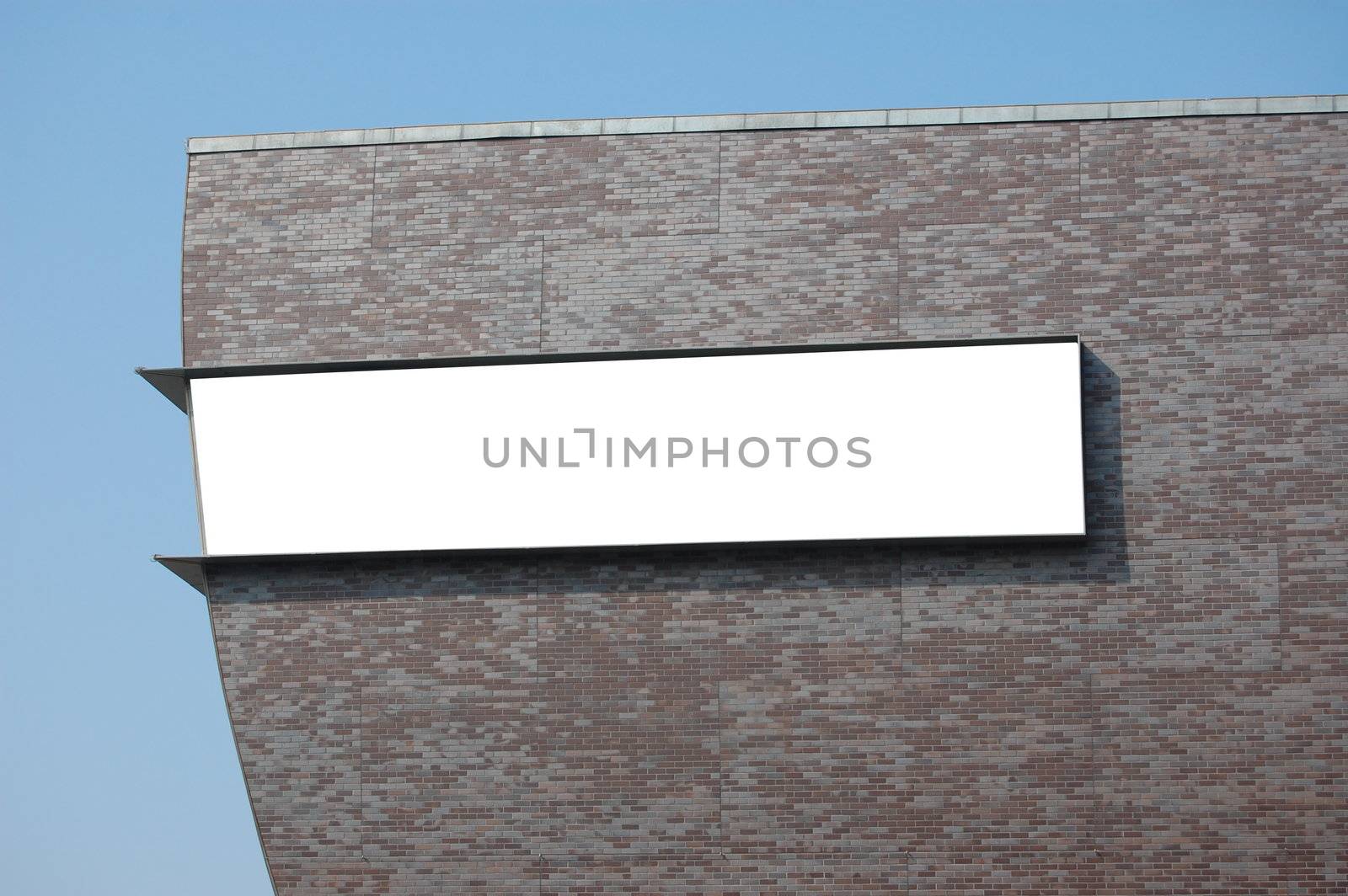 white empty billboard with copyspace for text and brickwall