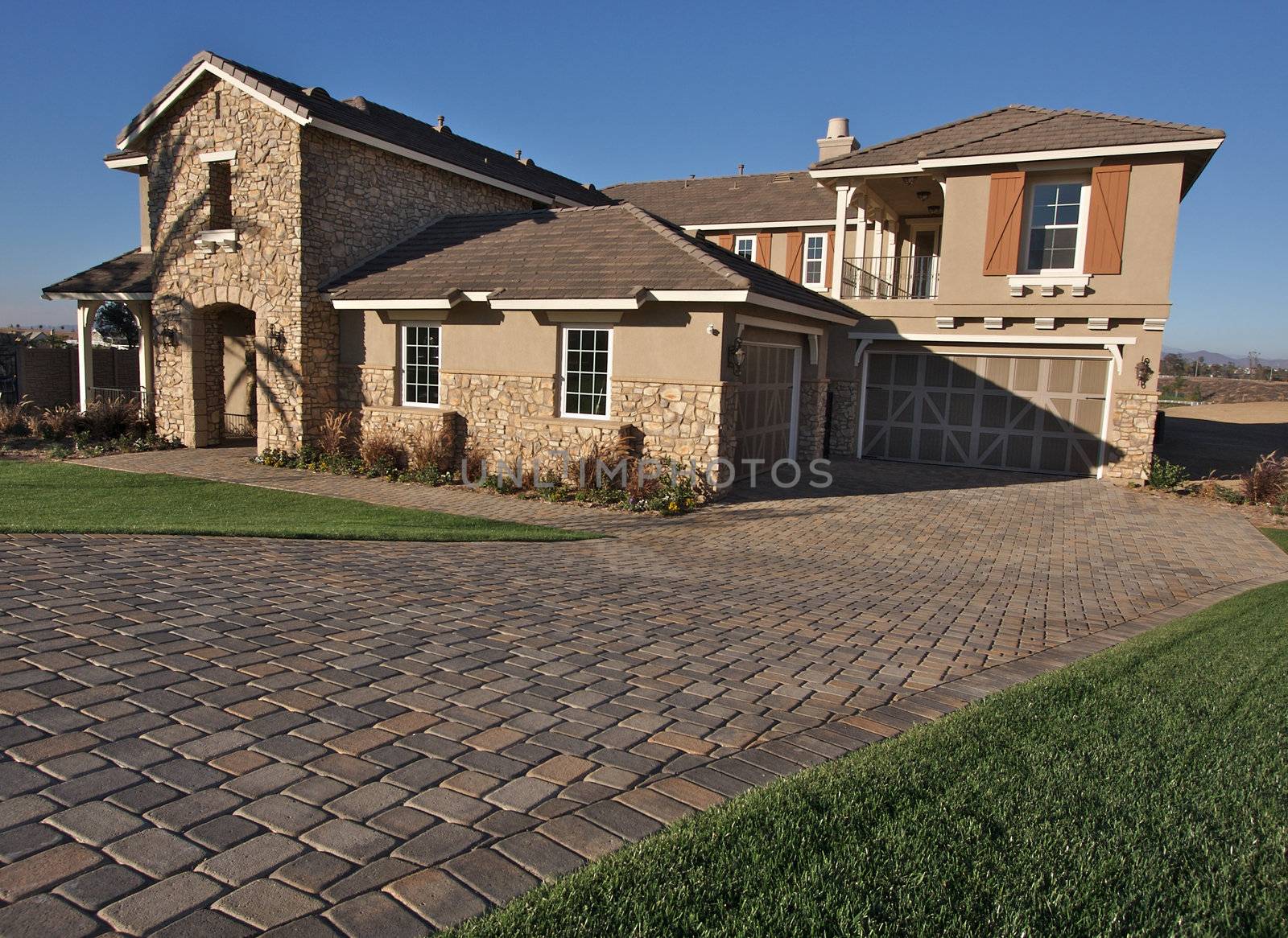 A newly constructed, modern american home with fresh landscaping.