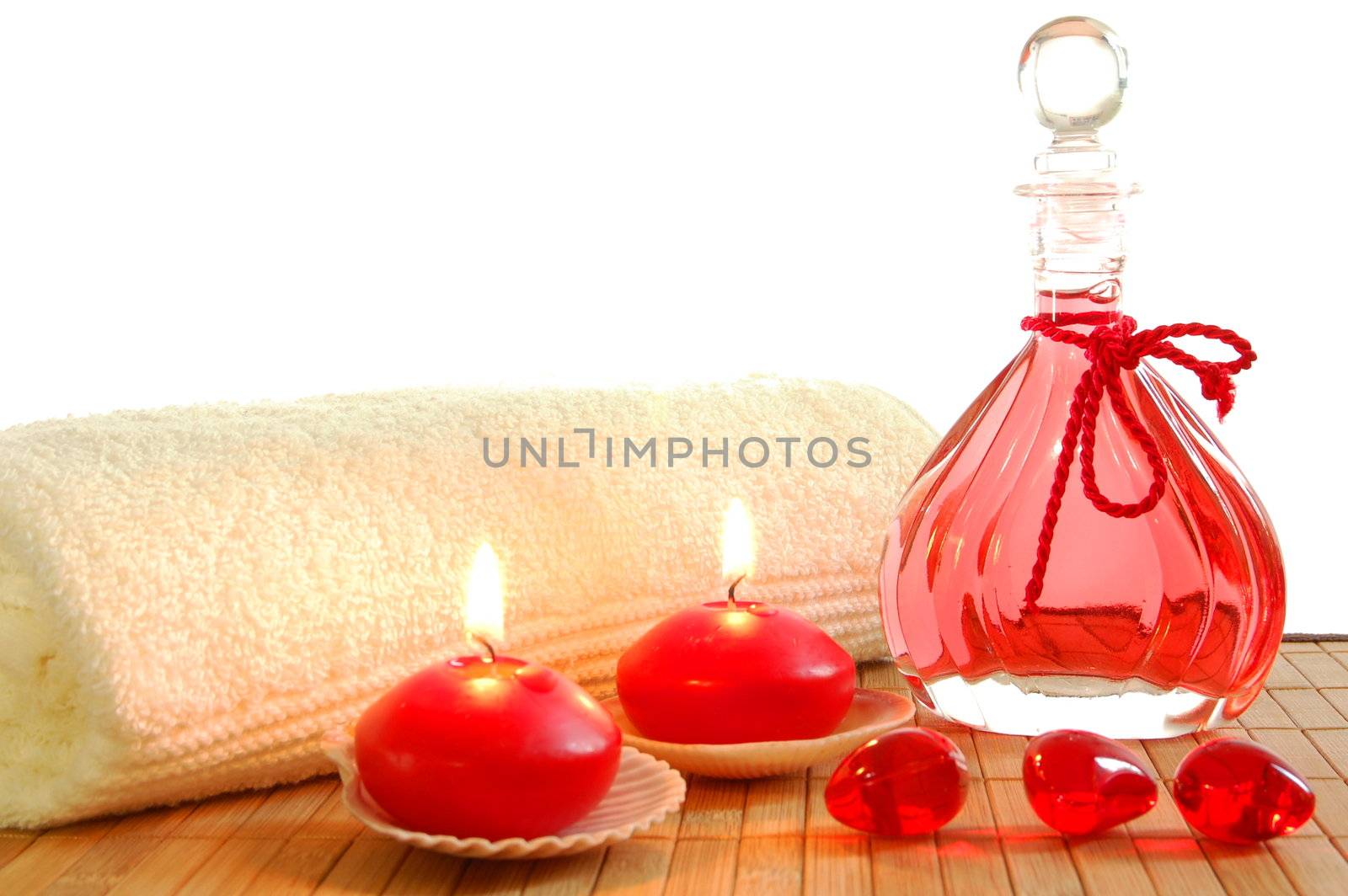 red spa decoration with massage oil bottle and candles