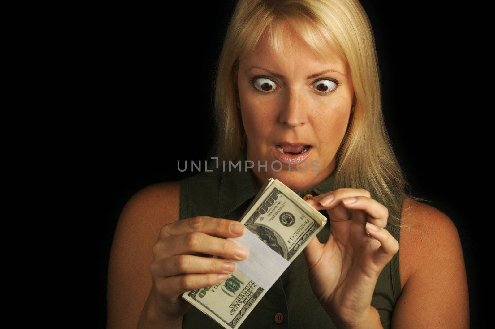 Attractive Woman Excited About her Stack of Money She Holds