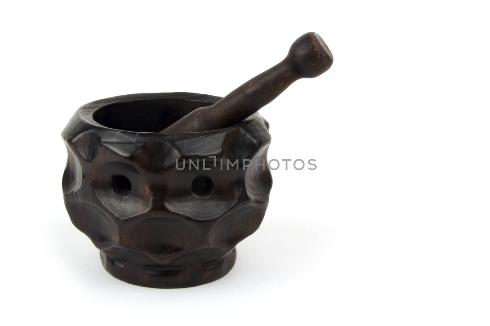 Wood mortar and pestle on a white background.