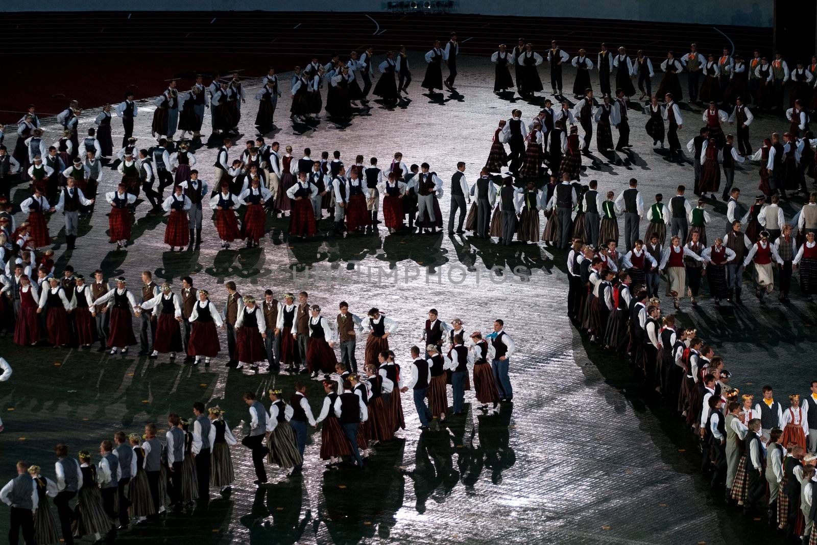 RIGA - JULY 9: Dancers in traditional costumes perform at the dress rehearsal of Grand Dance Performance during the Latvian Nationwide Song and Dance Celebration in Riga, Latvia, 9 July, 2008