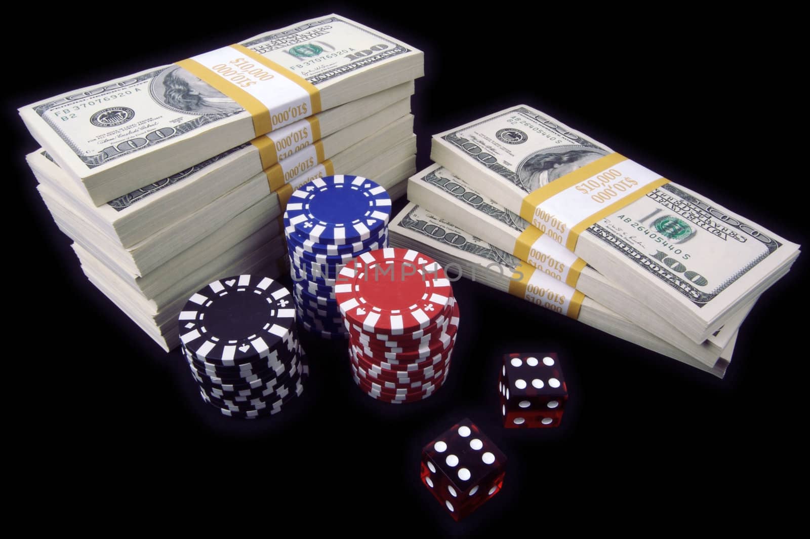 Stack of Ten Thousand Dollar Piles of One Hundred Dollar Bills, Red Dice & Poker Chips on a black background.