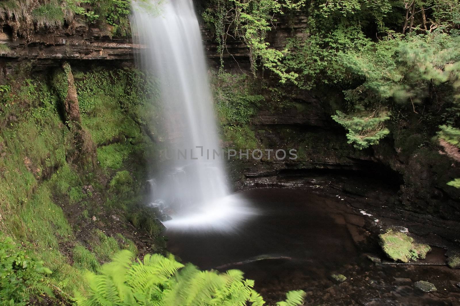 Waterfall creating feathery effect in water