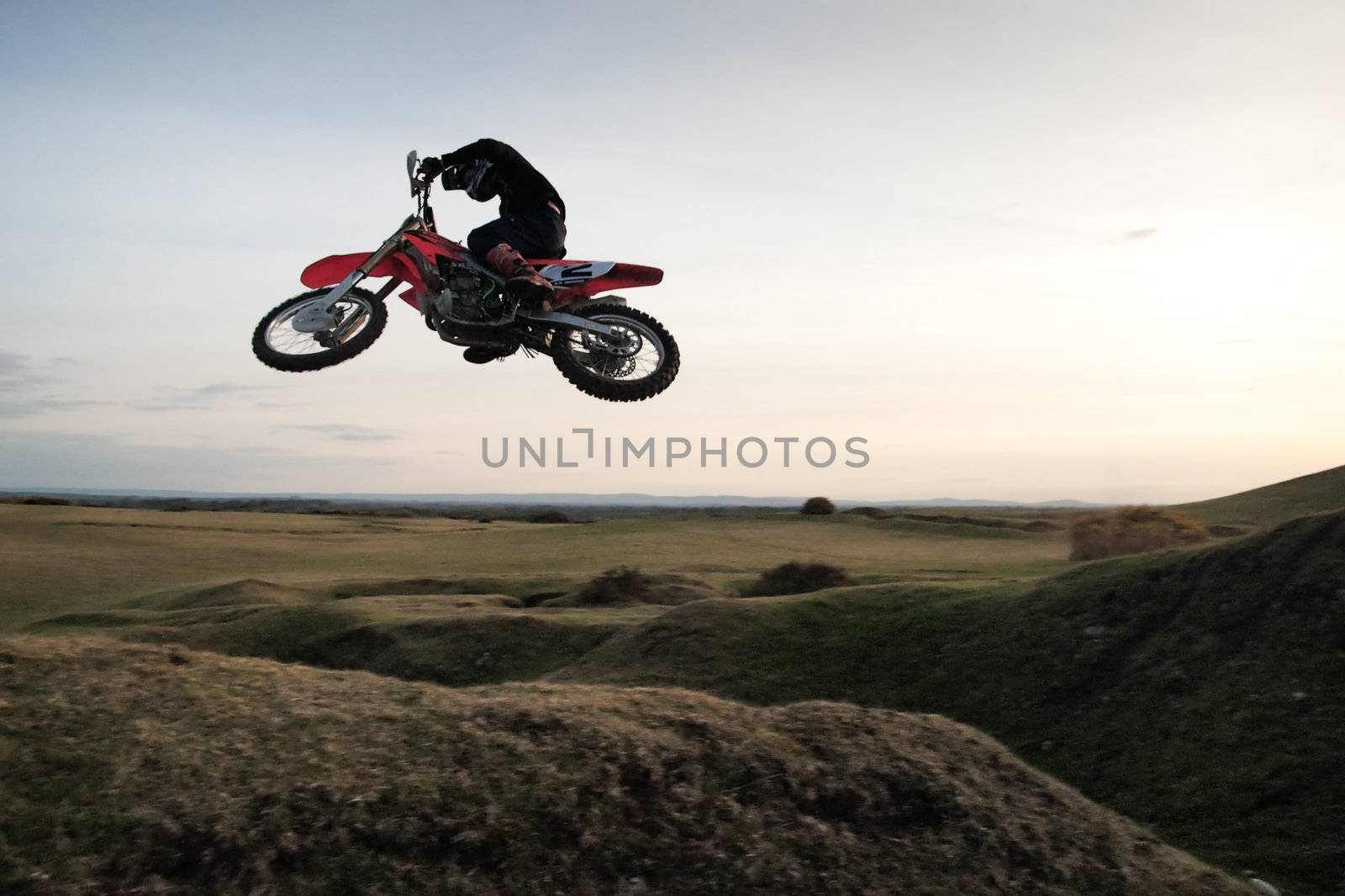 Motor cross rider jumping through the air