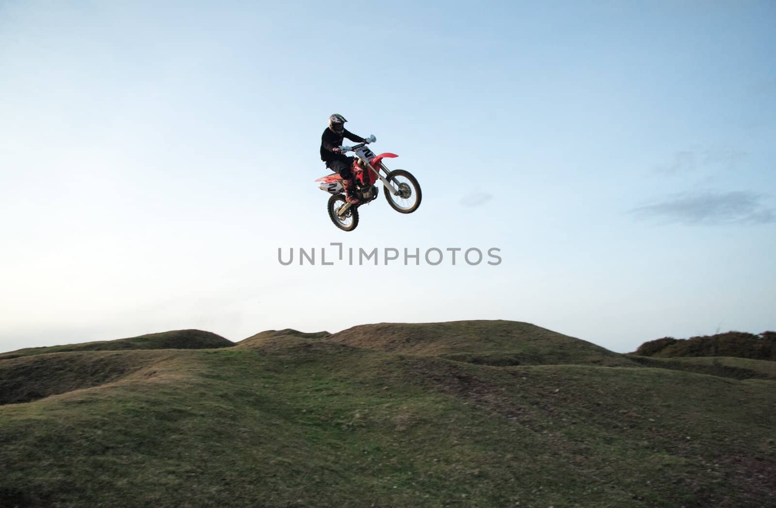 Motor cross rider jumping through the air
