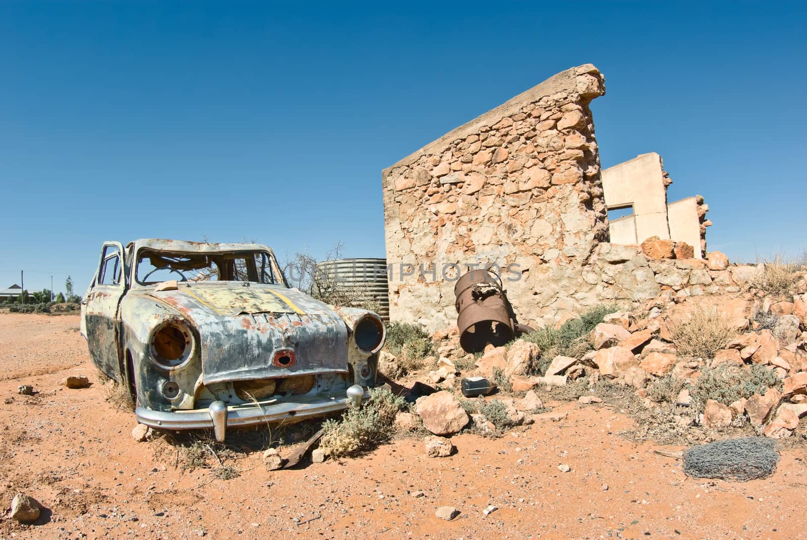 great image of an old car rusting away in the desert
