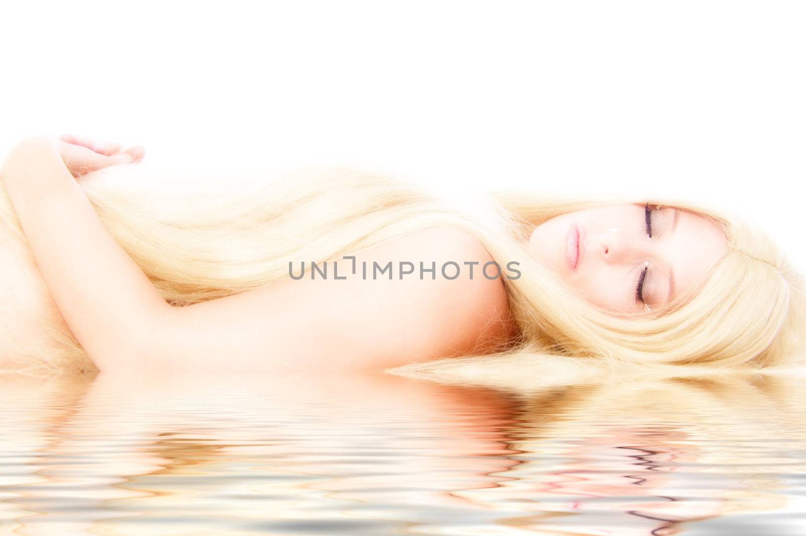 Beautiful blond model in the studio lying down like a princess by a pool