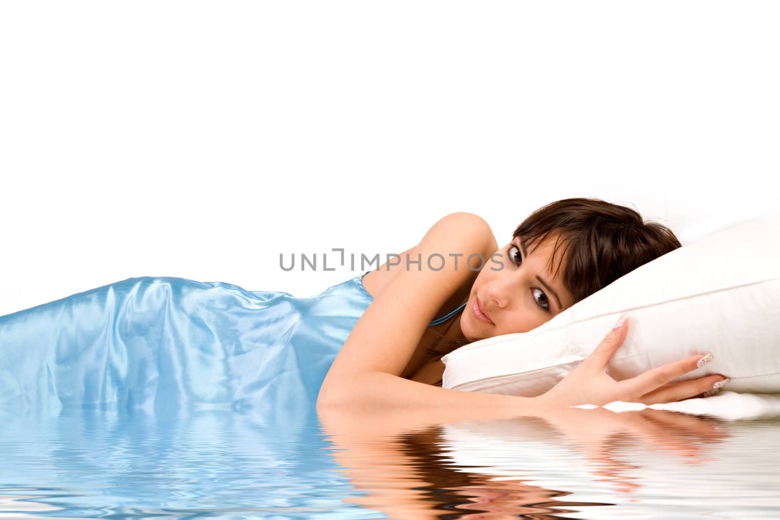 Cute girl in bed hugging her pillow on water