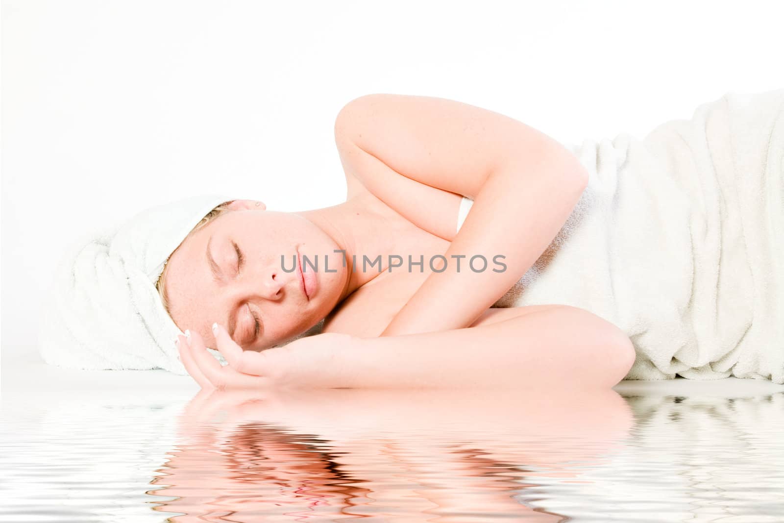 Studio portrait of a spa girl sleeping by the pool