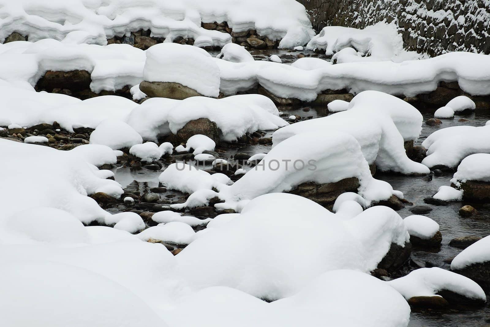 snowy river's stone in czech republic, horizontally framed shot