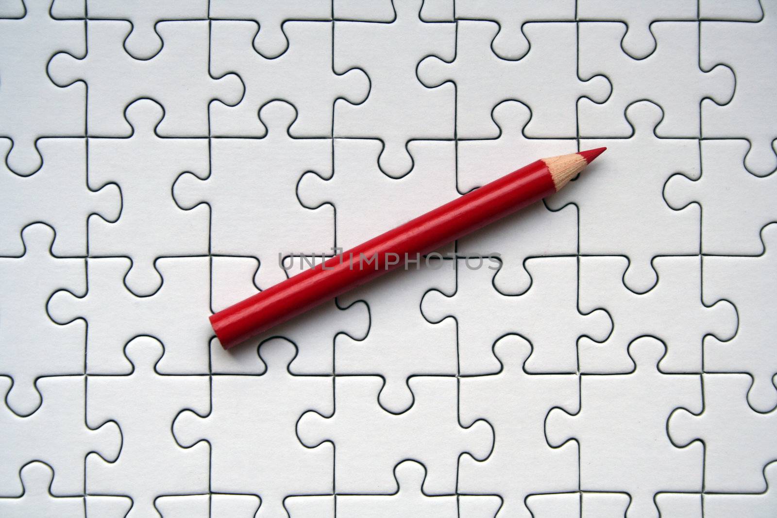 Jigsaw and red pencil by gautier