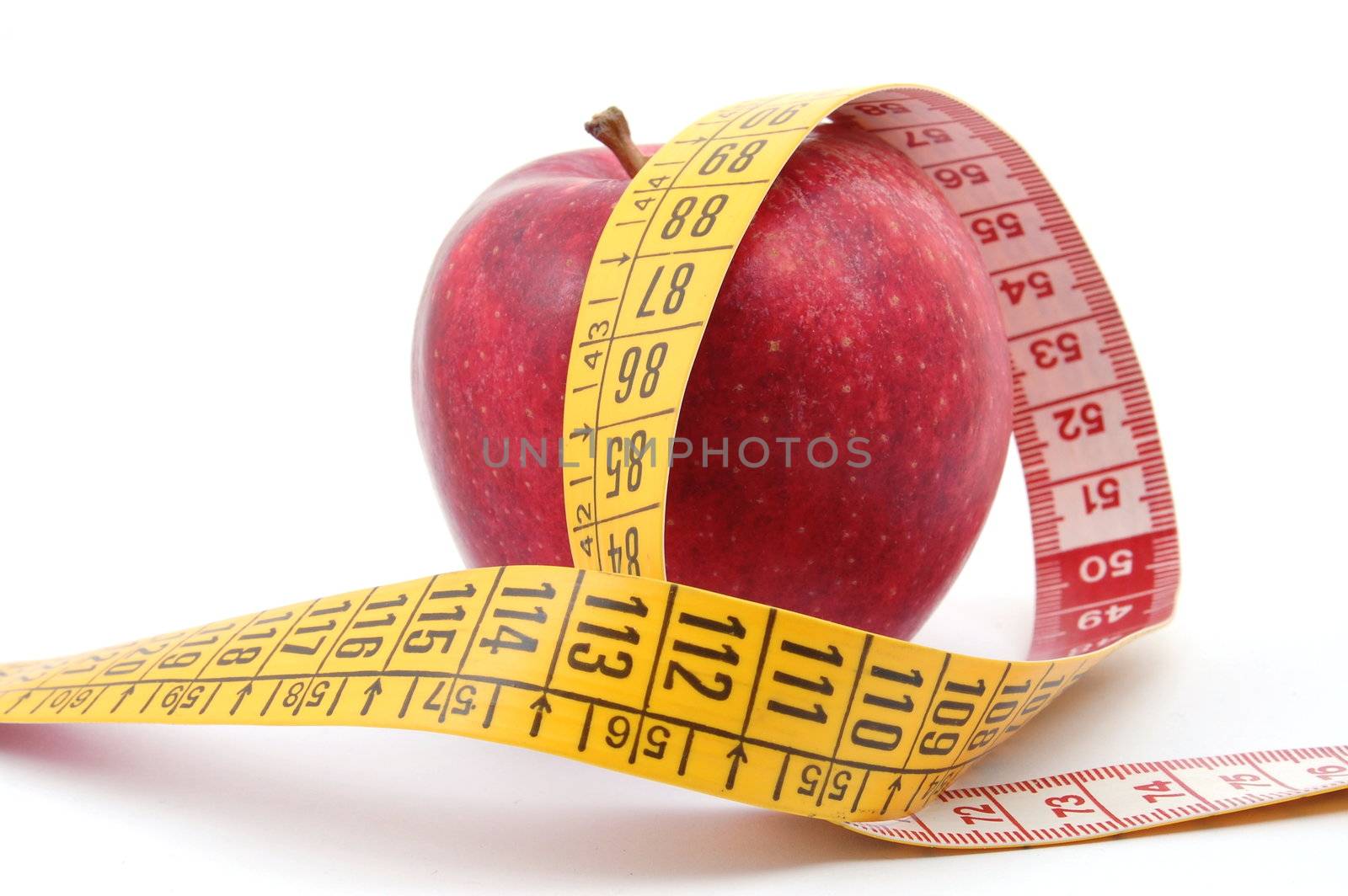 apple and measuring tape isolated on white background