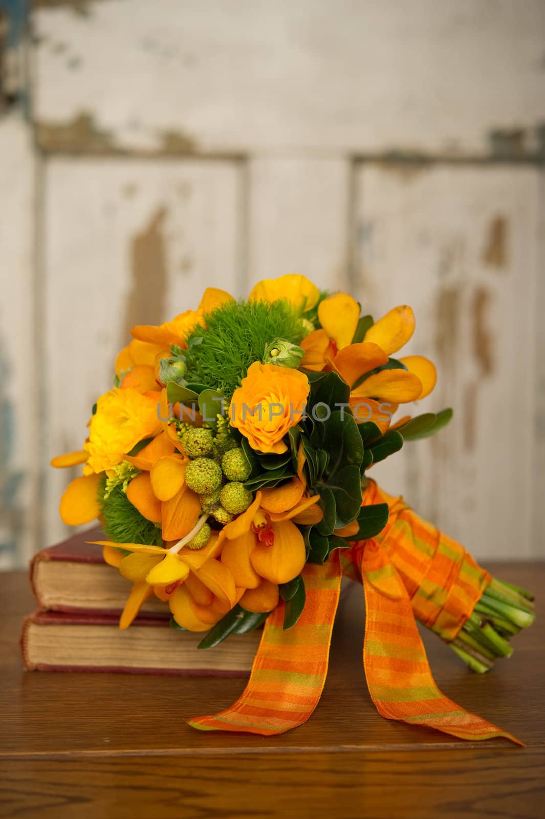 Image of a beautiful floral bouquet on stack of books