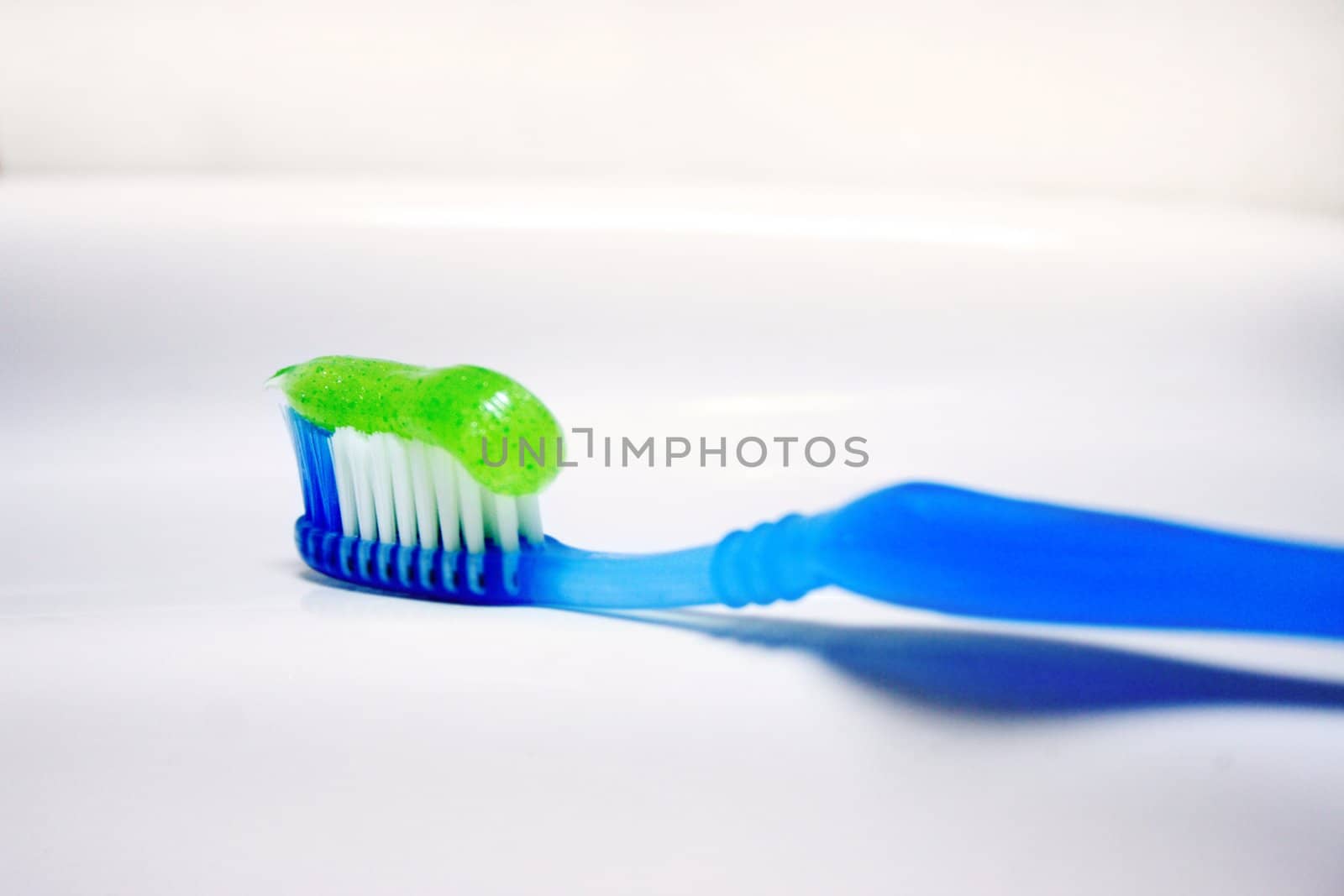 toothbrush with paste for cleaning teeth on background of the washstand