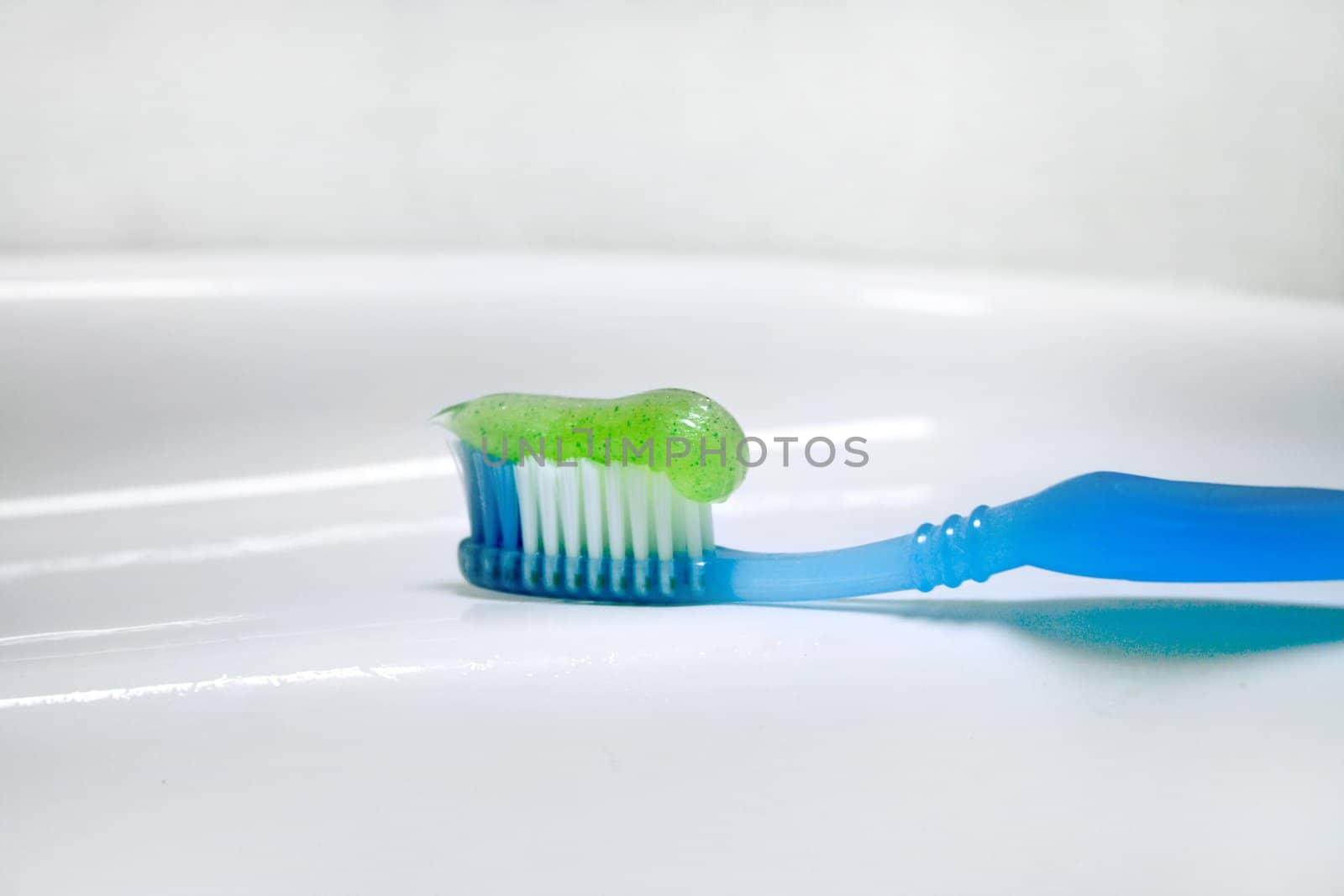 toothbrush with paste for cleaning teeth on background of the washstand