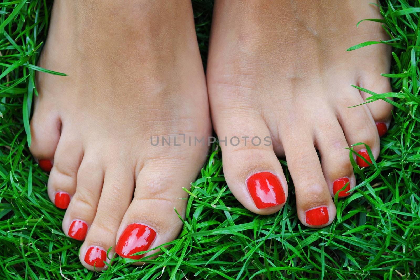 Red nails on the green grass