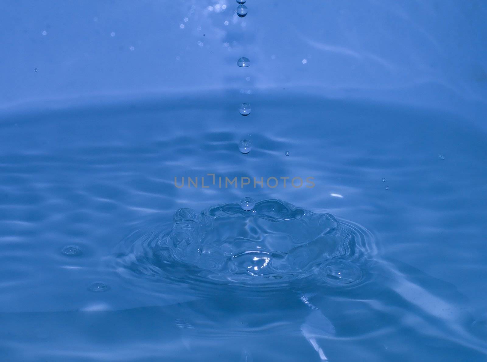 splash of blue water with small drops motion