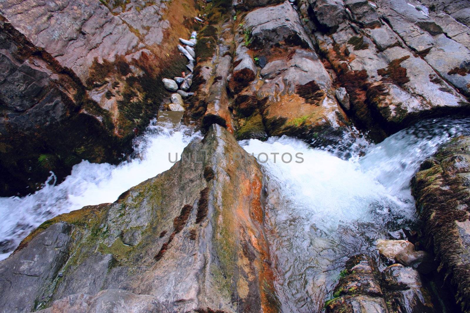 tempestuous clean mountain river with waterfall in stone granite break