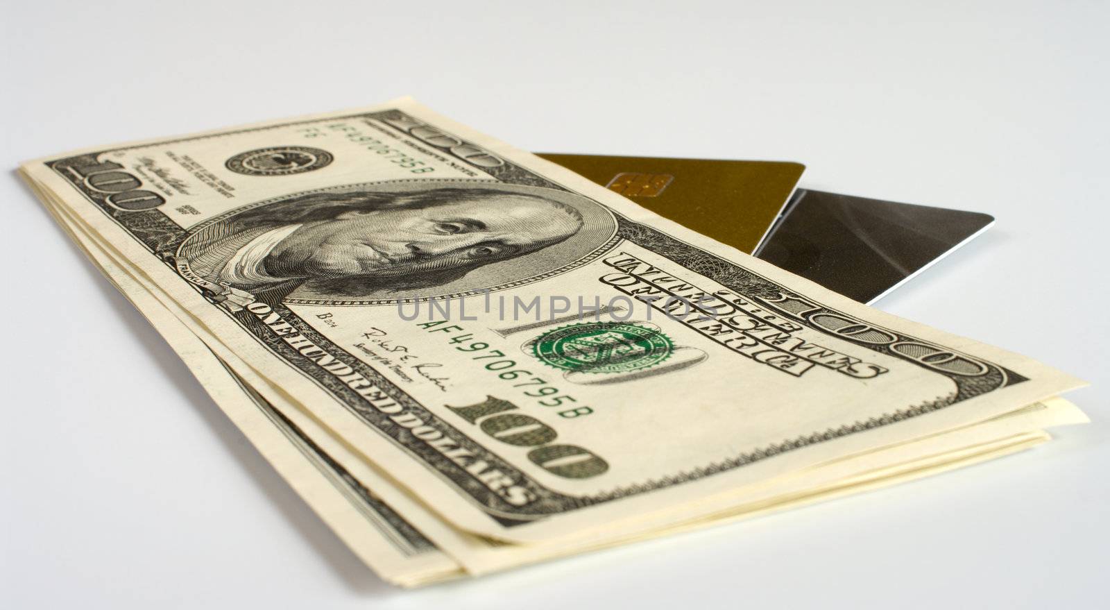 Credit cards and dollars on a white background.