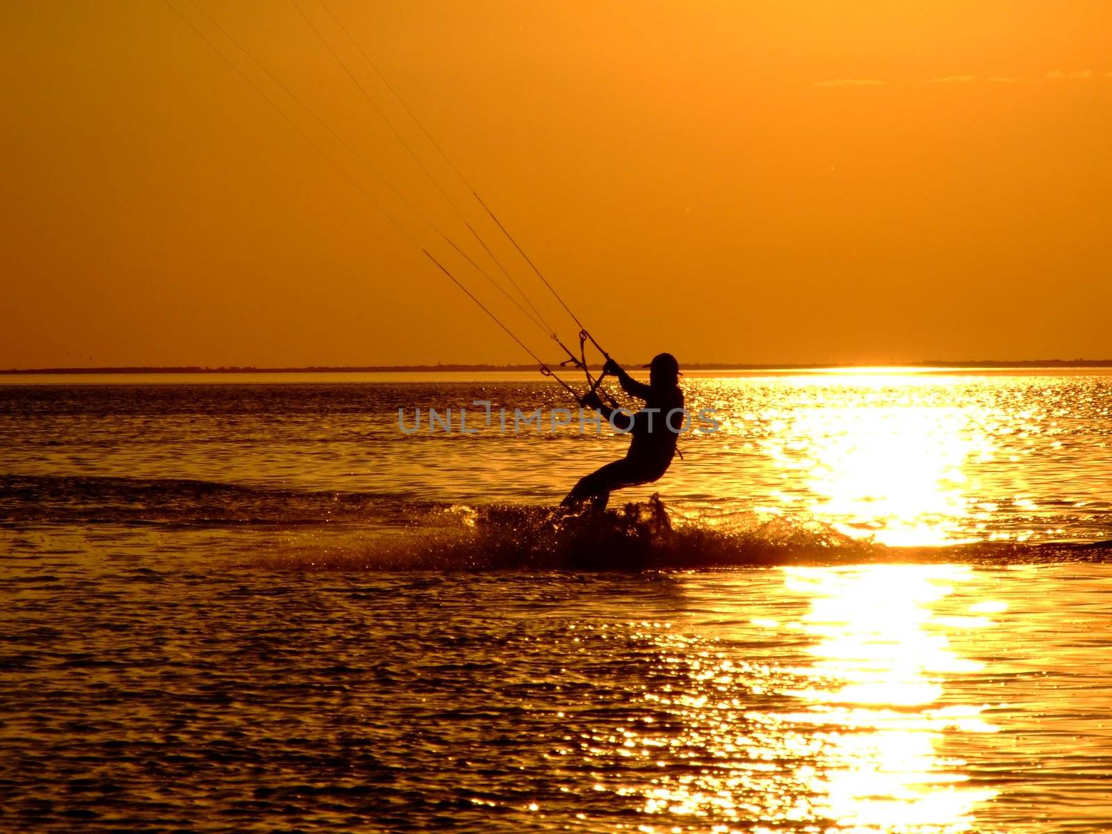 Silhouette of a kitesurf on a gulf on a sunset 2