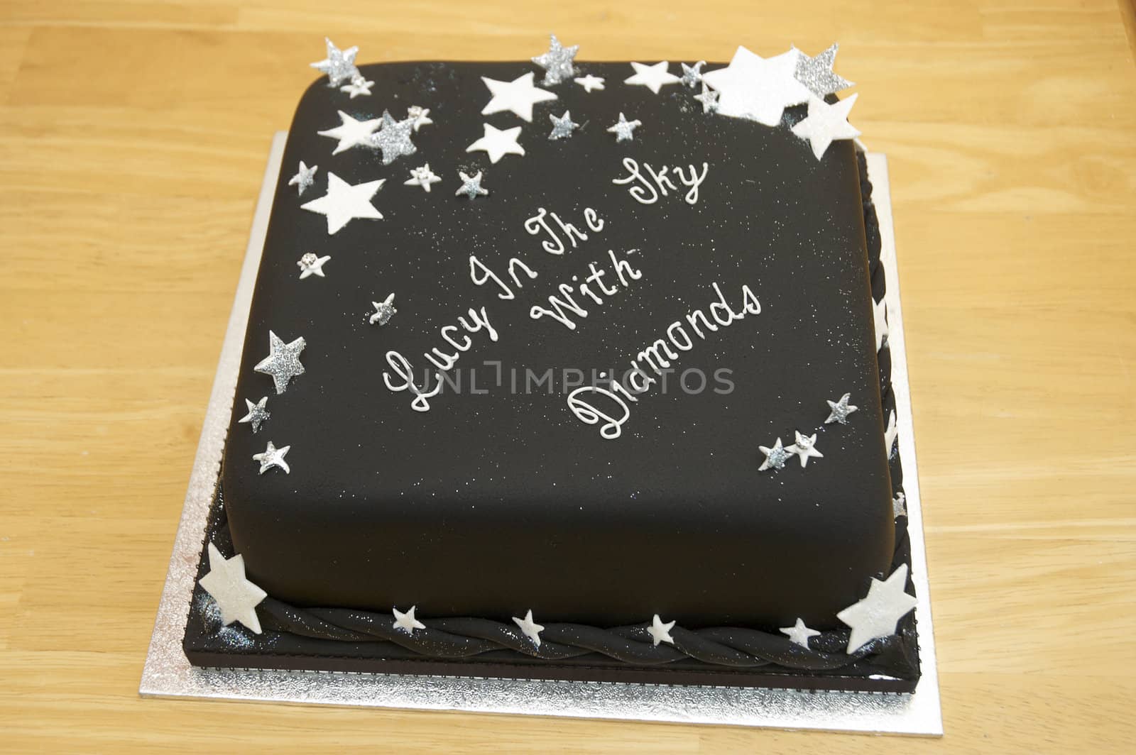 A black birthday cake on a table