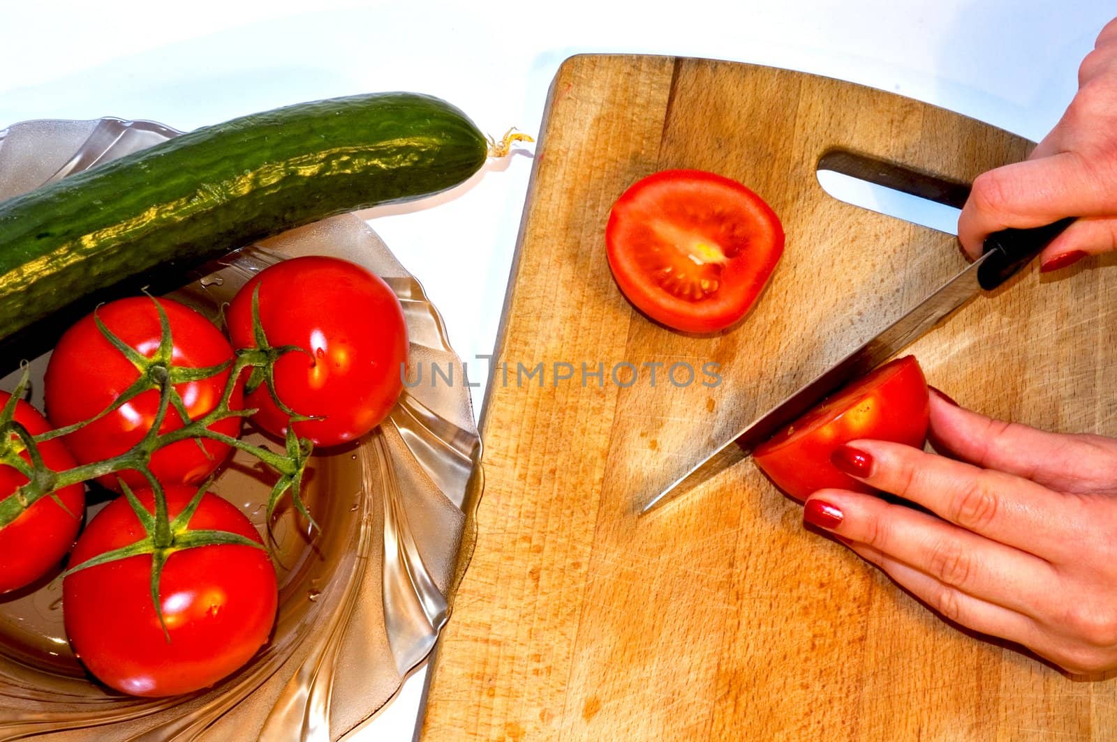 Women cut tomato