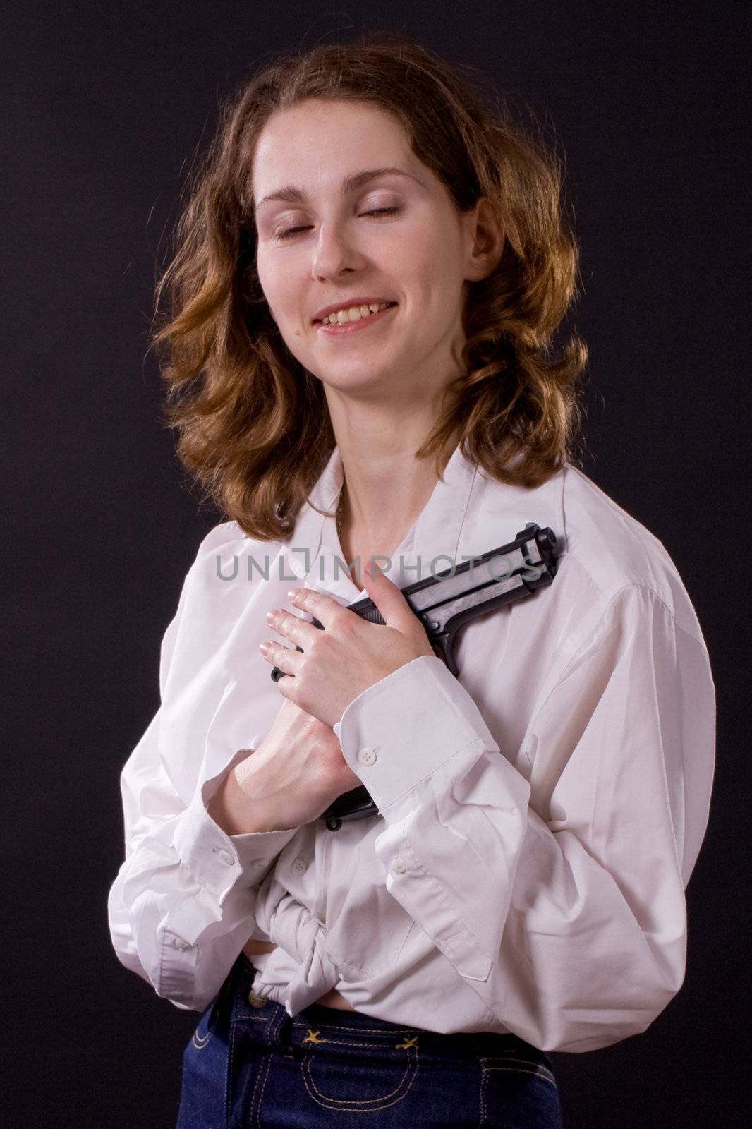 woman on black handing gun
