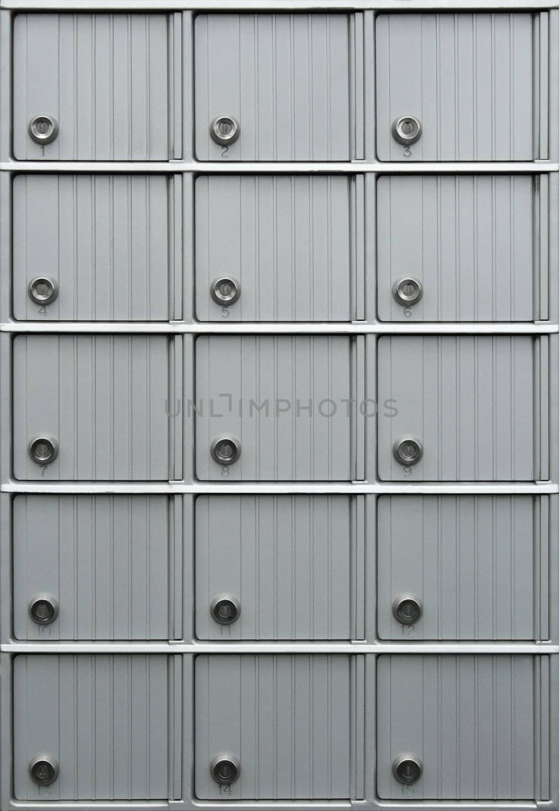 Rows of metallic mailboxes with numbers.